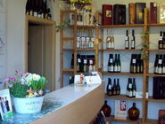 Innenansicht Verkaufsraum - Regal mit Weinflaschen und Verkaufstresen